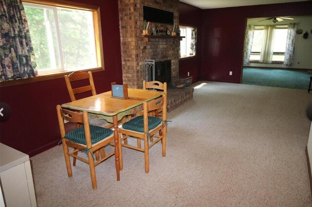 42491 432nd Ln, Aitkin, MN 56431 - dining space featuring carpet floors, a fireplace, and ceiling fan