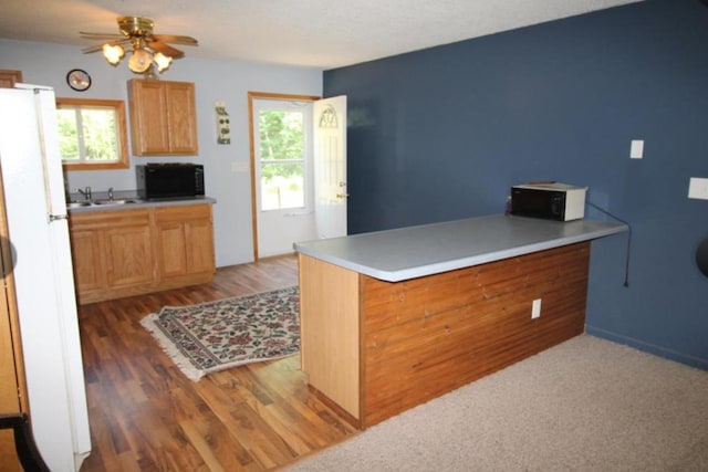 42491 432nd Ln, Aitkin, MN 56431 - kitchen featuring black microwave, a ceiling fan, a sink, and freestanding refrigerator