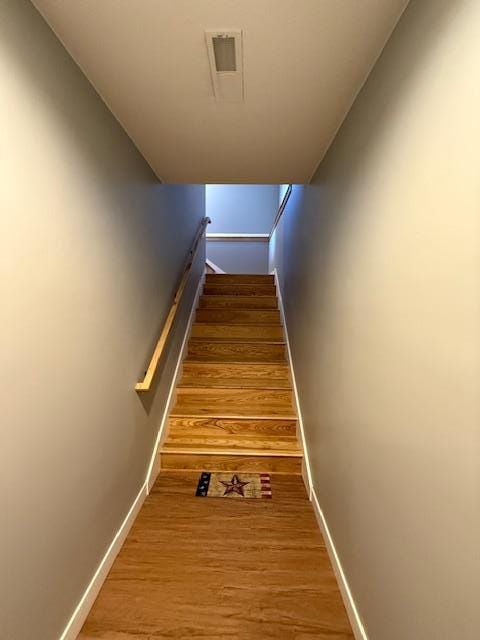 817 2nd St N, Brownsville, MN 55919 - staircase with baseboards, wood finished floors, and visible vents