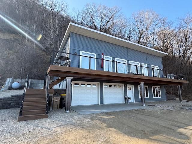 817 2nd St N, Brownsville, MN 55919 - contemporary house featuring a garage, stairs, and driveway