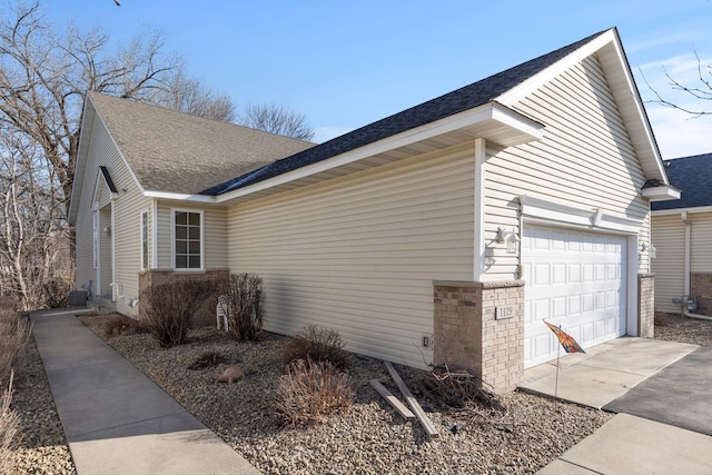 1129 Seurer St, Elko New Market, MN 55054 - view of property exterior featuring cooling unit, a shingled roof, an attached garage, and concrete driveway