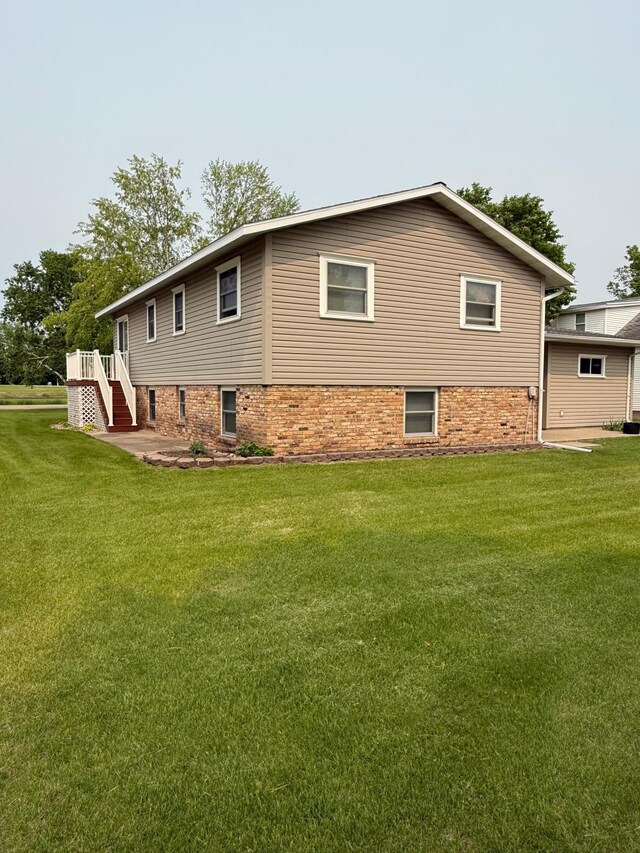 404 Balmoral Ave, Henning, MN 56551 - view of side of home featuring a yard and stairway