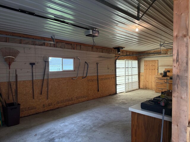 404 Balmoral Ave, Henning, MN 56551 - garage featuring a garage door opener and wooden walls