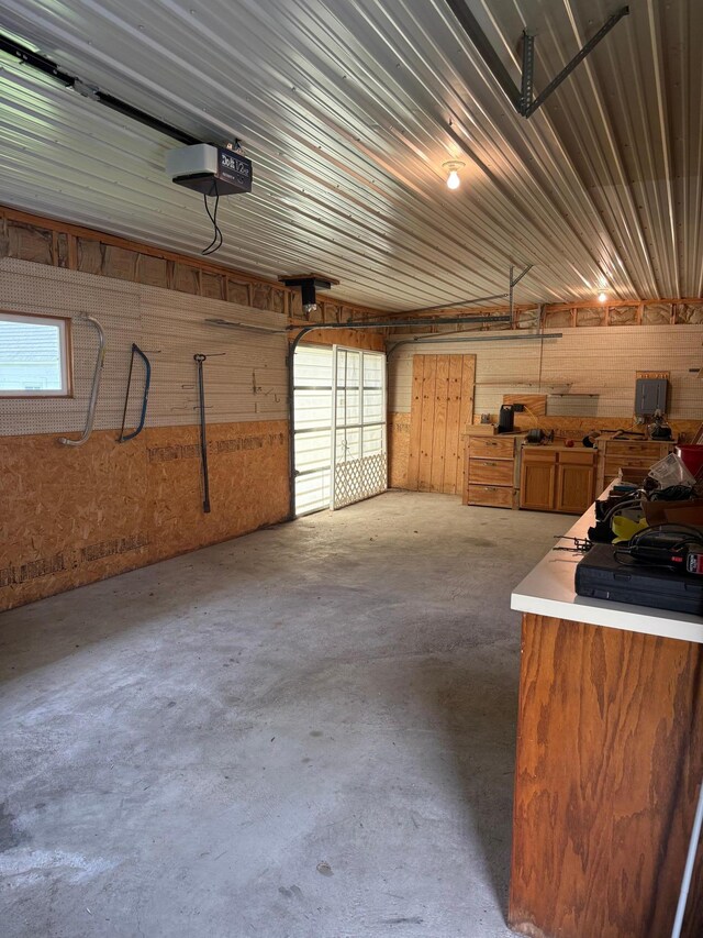 404 Balmoral Ave, Henning, MN 56551 - garage with a garage door opener and wooden walls