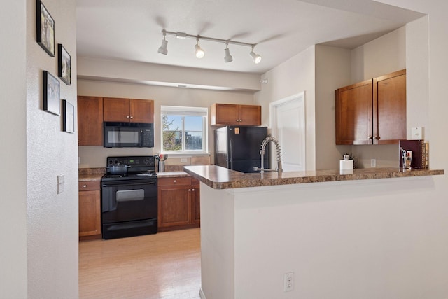13560 Technology Dr Unit 1210, Eden Prairie, MN 55344 - kitchen featuring black appliances, a peninsula, and brown cabinets