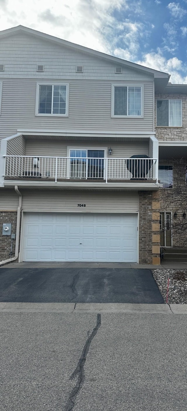 7048 Park Dr, Savage, MN 55378 - townhome / multi-family property with driveway and a garage