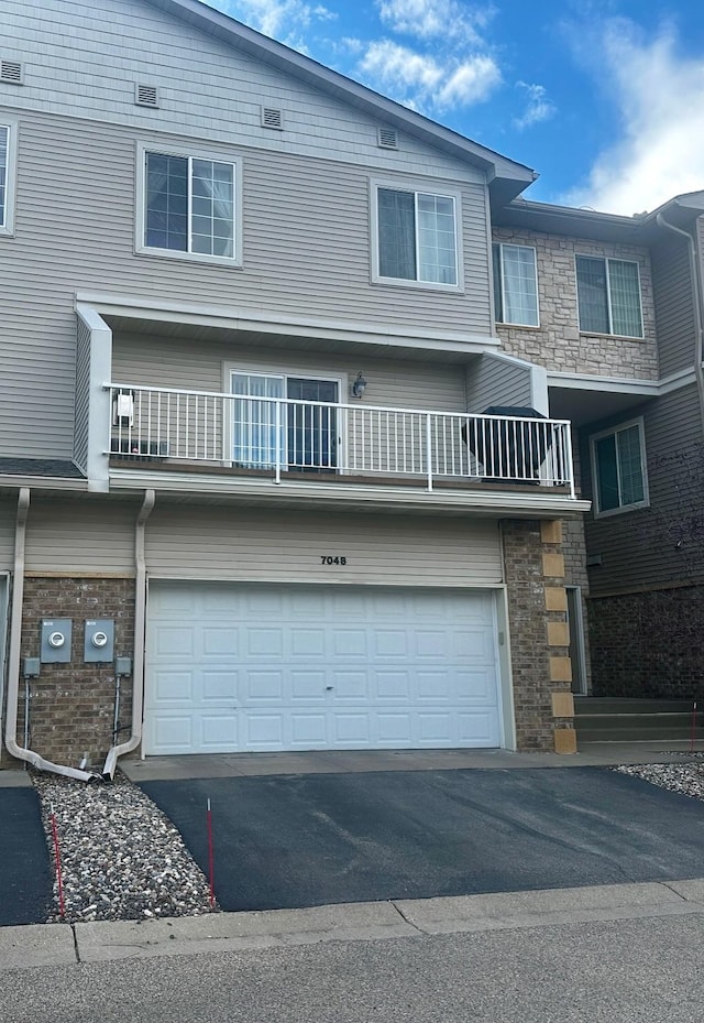 7048 Park Dr, Savage, MN 55378 - multi unit property with stone siding, a garage, and aphalt driveway