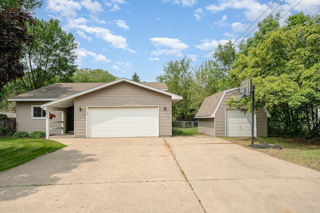 949 Xenia Ave NW, Elk River, MN 55330 - view of front of home with an outdoor structure, a shingled roof, and a garage