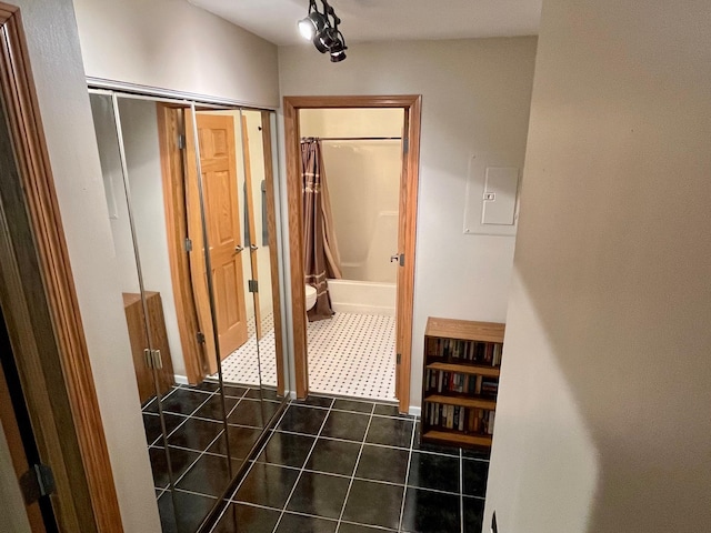 corridor with dark tile patterned flooring