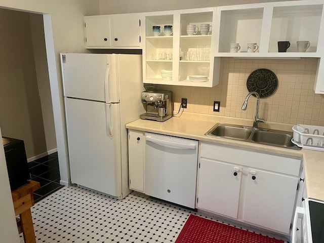 kitchen with white appliances, a sink, open shelves, light countertops, and tasteful backsplash