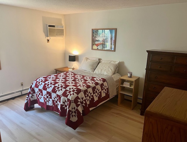 bedroom with wood finished floors, a wall mounted AC, and a baseboard heating unit