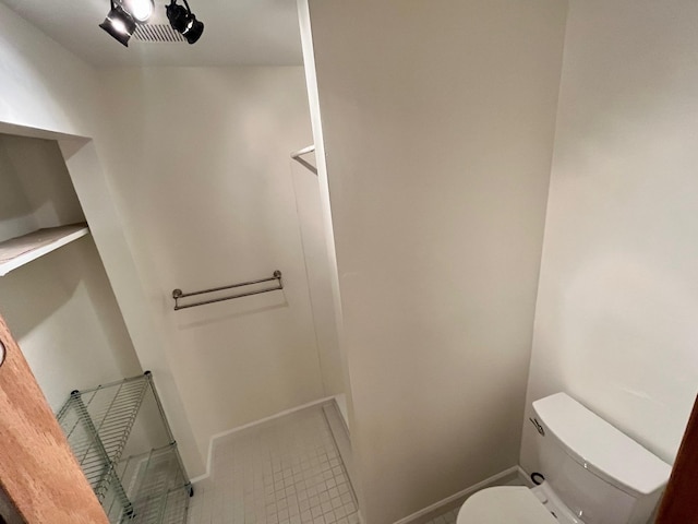 bathroom featuring toilet and baseboards