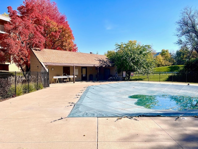 view of pool with a patio and fence