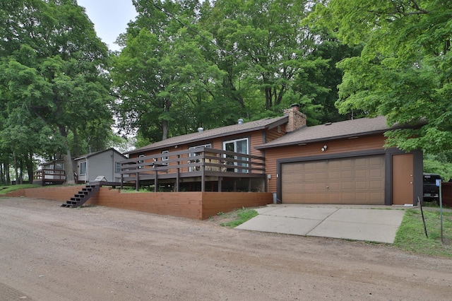 27672 Little Whitefish Rd, Garrison, MN 56450 - view of front of house featuring a chimney, a garage, and concrete driveway