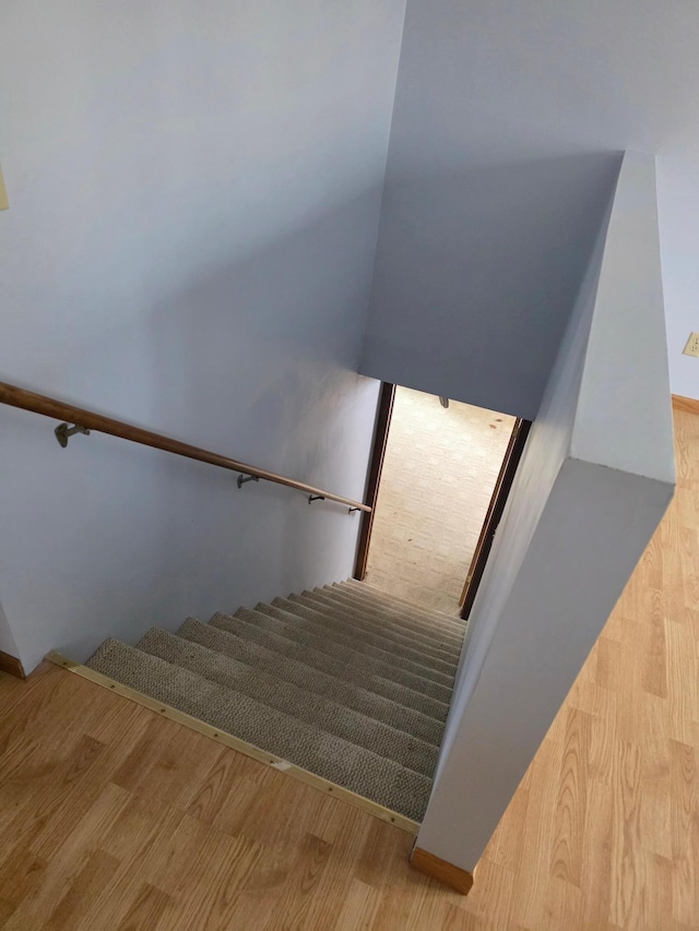 stairs featuring wood finished floors