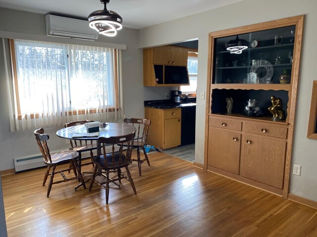 713 Maple Dr, Aurora, MN 55705 - dining room with plenty of natural light, light wood-style floors, and a wall mounted air conditioner
