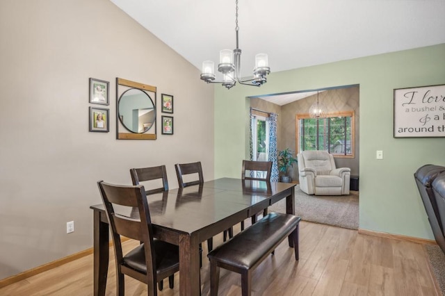 108 Serenity Cir, Buffalo, MN 55313 - dining area with a chandelier, light wood-style floors, baseboards, and vaulted ceiling