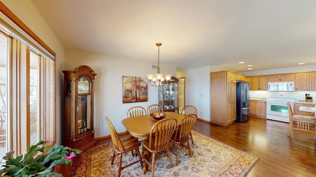 dining room featuring visible vents, wood finished floors, baseboards, a chandelier, and recessed lighting
