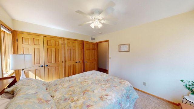 carpeted bedroom featuring visible vents, baseboards, ceiling fan, and a closet