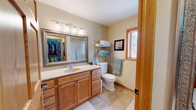 bathroom with toilet and vanity