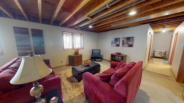 carpeted living room with baseboards