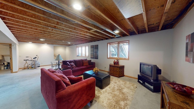 carpeted living room featuring baseboards and a wood stove