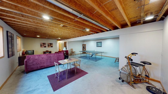 playroom with concrete flooring and baseboards