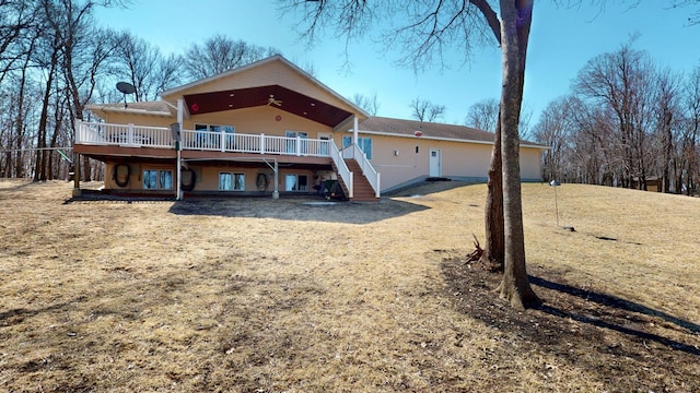 back of property featuring stairway and a deck