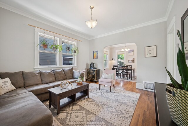 4336 Aldrich Ave S, Minneapolis, MN 55409 - living room with arched walkways, ornamental molding, wood finished floors, a chandelier, and baseboards