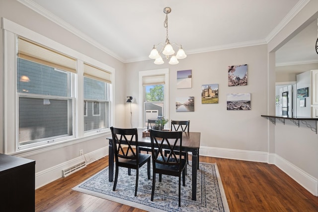 4336 Aldrich Ave S, Minneapolis, MN 55409 - dining area featuring a chandelier, dark wood finished floors, baseboards, and crown molding