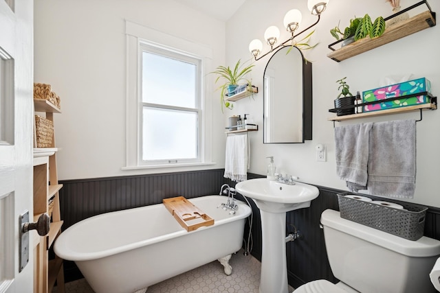 4336 Aldrich Ave S, Minneapolis, MN 55409 - bathroom featuring a wainscoted wall, plenty of natural light, a freestanding tub, and toilet