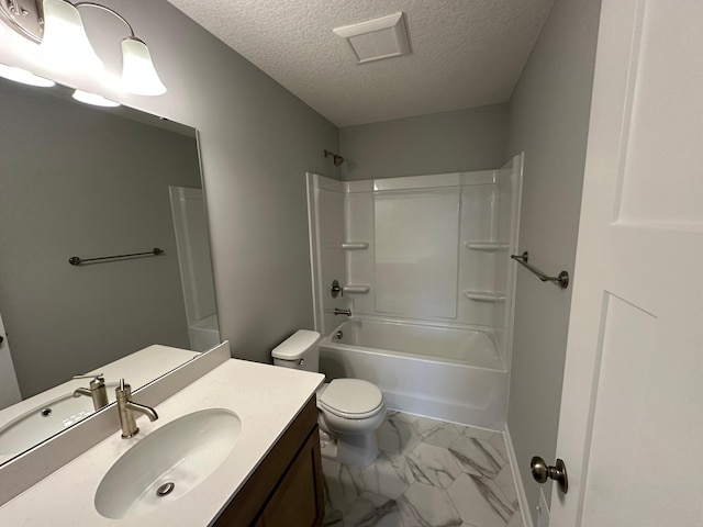 bathroom featuring vanity, toilet, marble finish floor, visible vents, and a textured ceiling