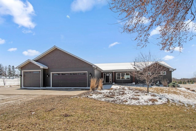 ranch-style home featuring an attached garage and concrete driveway