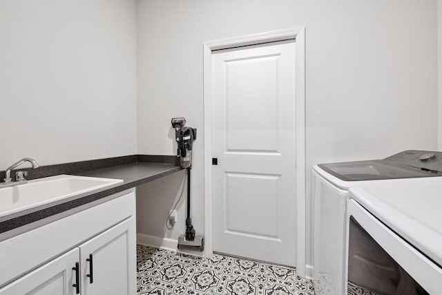 laundry area with a sink, light tile patterned floors, cabinet space, and washer and dryer