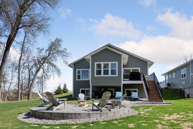 back of house with a lawn, a fire pit, a patio area, and stairway