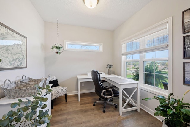 office space featuring baseboards and wood finished floors