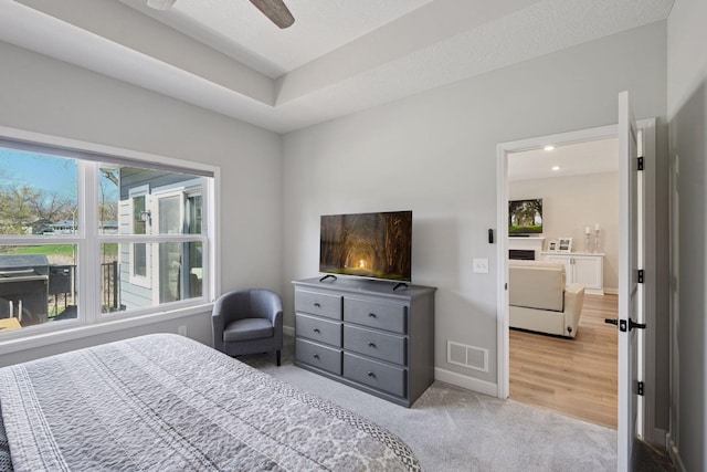 bedroom featuring baseboards, multiple windows, light carpet, and visible vents