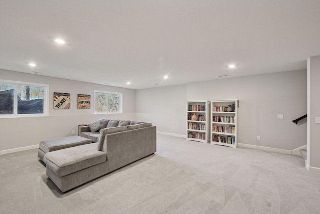 carpeted living area with recessed lighting, baseboards, a healthy amount of sunlight, and stairway
