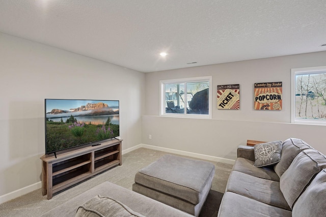 living area featuring carpet floors, baseboards, recessed lighting, and a textured ceiling