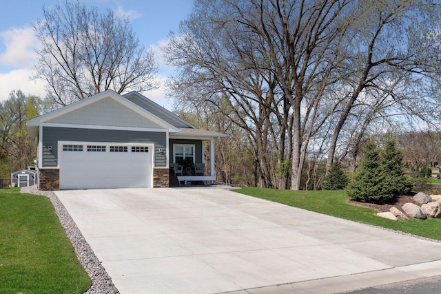 view of front of home with an attached garage, stone siding, and a front lawn