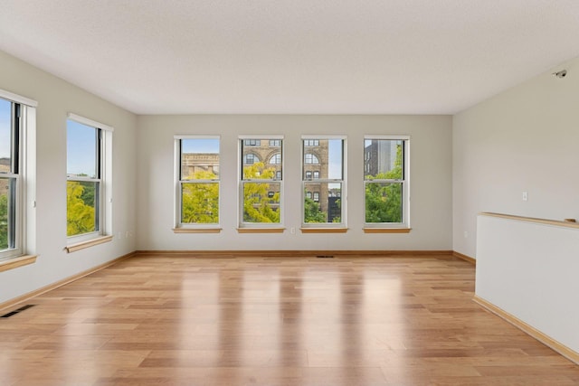 645 1st St Unit 411, Minneapolis, MN 55401 - spare room with light wood-type flooring and baseboards