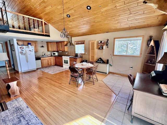 4832 Ambassador Point Ct, Leiding Twp, MN 55771 - dining space with wood ceiling, light wood-type flooring, a chandelier, baseboards, and high vaulted ceiling