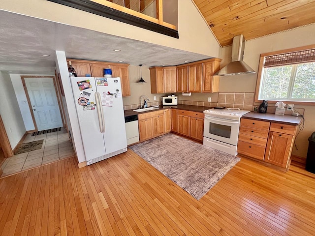 4832 Ambassador Point Ct, Leiding Twp, MN 55771 - kitchen featuring white appliances, wall chimney range hood, a sink, light wood-style flooring, and high vaulted ceiling