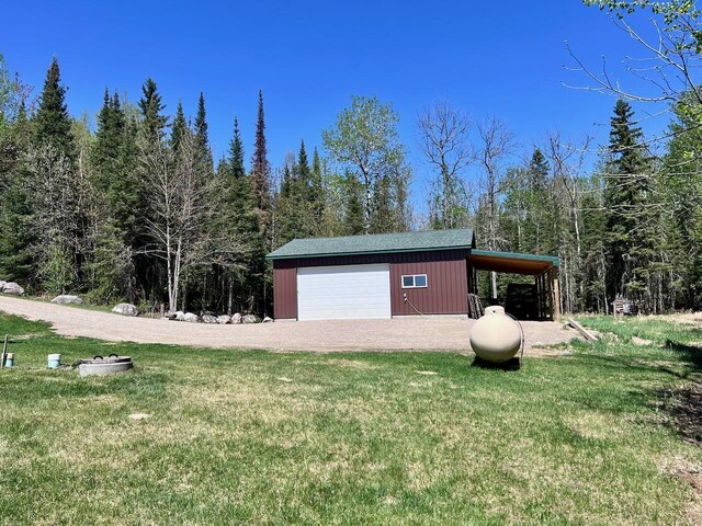 4832 Ambassador Point Ct, Leiding Twp, MN 55771 - view of outdoor structure featuring an outbuilding, driveway, and a forest view