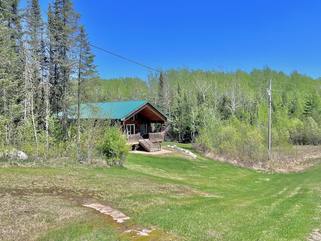 4832 Ambassador Point Ct, Leiding Twp, MN 55771 - view of green lawn featuring a forest view, stairs, and a wooden deck
