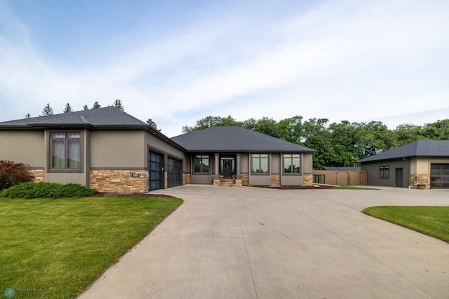 4109 66th St S, West Fargo, ND 58104 - prairie-style home with stone siding, driveway, stucco siding, and a garage