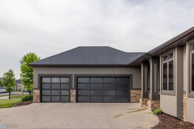 4109 66th St S, West Fargo, ND 58104 - view of home's exterior featuring stone siding, a garage, and stucco siding