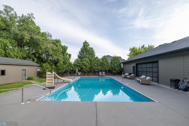 4109 66th St S, West Fargo, ND 58104 - view of pool featuring an outdoor hangout area, a water slide, a patio, and a fenced backyard