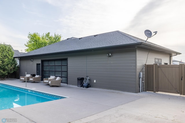 4109 66th St S, West Fargo, ND 58104 - back of property with an outdoor hangout area, a patio, a gate, and a shingled roof