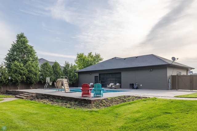4109 66th St S, West Fargo, ND 58104 - back of property with a fenced backyard, a patio, a gate, a garage, and roof with shingles